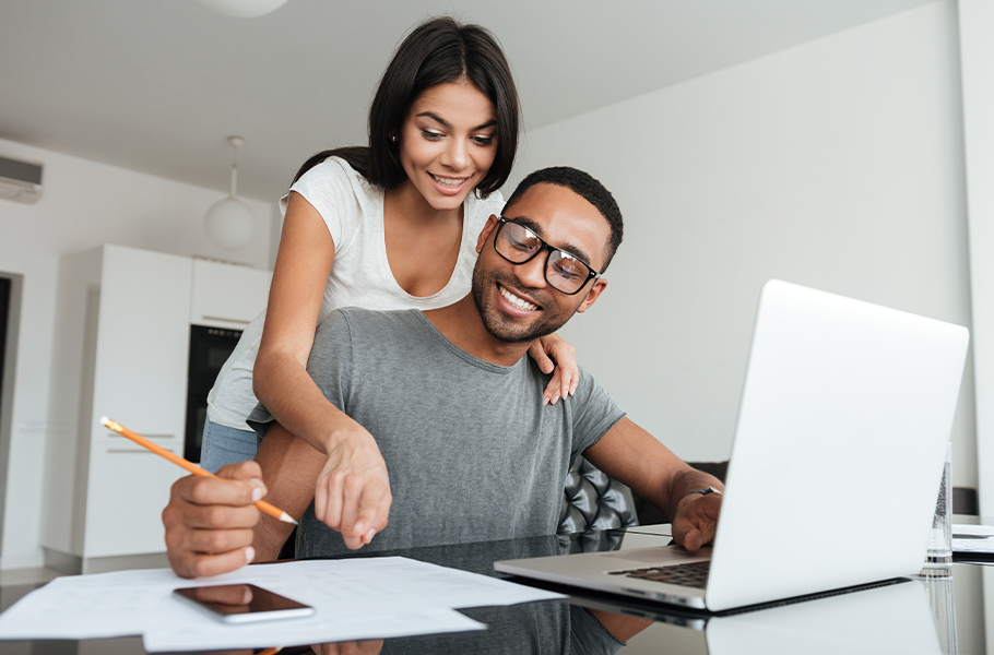 loving young couple using laptop and analyzing their finances